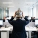A woman at work, seen from the back, donning a gladiator helmet